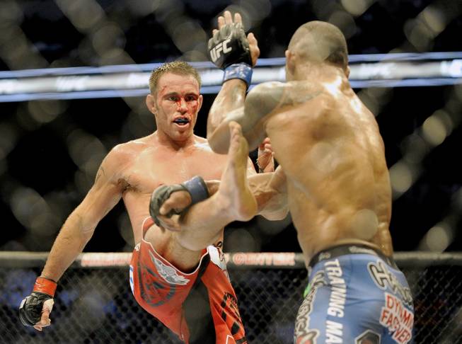 Jake Shields, left, tries to land a kick on Hector Lombard during a UFC 171 mixed martial arts welterweight bout on Saturday, March. 15, 2014, in Dallas. Lombard won by decision.